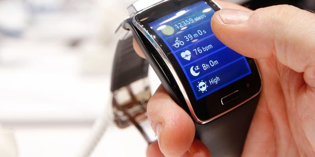 A visitor holds a Samsung Gear S smartwatch at the IFA consumer technology fair in Berlin, September 5, 2014.