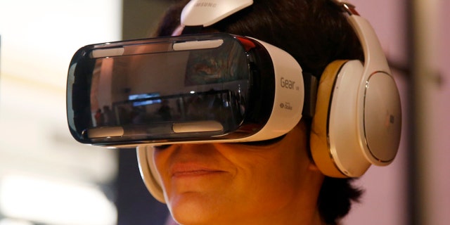 An attendee tries an Oculus-powered Samsung Gear VR headset during French telecom company Orange's annual innovations show in Paris Oct. 2, 2014.
