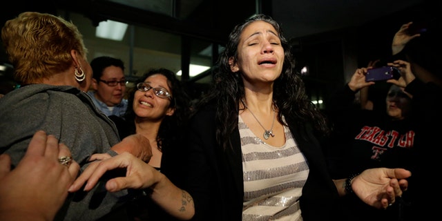 Cassandra Rivera, center, followed by Elizabeth Ramirez and Kristie Mayhugh are greeted by family as they leave the Bexar County Jail, Monday, Nov. 18, 2013, in San Antonio, after it was announced earlier in the day the San Antonio women imprisoned for sexually assaulting two girls in 1994 were expected to walk free Monday after a judge agreed that their convictions were tainted by faulty witness testimony. Vasquez, the fourth, has already been paroled, but under strict conditions. (AP Photo/Eric Gay)