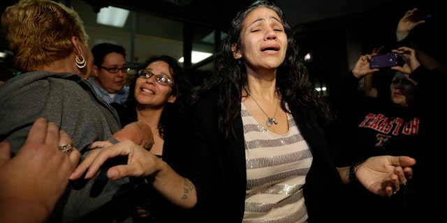 Cassandra Rivera, center, followed by Elizabeth Ramirez and Kristie Mayhugh are greeted by family as they leave the Bexar County Jail, Monday, Nov. 18, 2013, in San Antonio, after it was announced earlier in the day the San Antonio women imprisoned for sexually assaulting two girls in 1994 were expected to walk free Monday after a judge agreed that their convictions were tainted by faulty witness testimony. Vasquez, the fourth, has already been paroled, but under strict conditions. (AP Photo/Eric Gay)