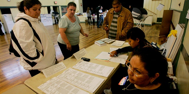SAN DIEGO, CA - NOVEMBER 4: Voters prepare to cast their ballots at Our Lady of Angels Catholic Church November 4, 2008 in San Diego, California. After nearly two years of presidential campaigning, U.S. citizens go to the polls today to vote in the election between Democratic presidential nominee U.S. Sen. Barack Obama (D-IL) and Republican nominee U.S. Sen. John McCain (R-AZ). (Photo by Sandy Huffaker/Getty Images)