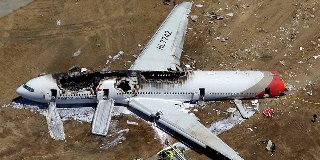 File - In this July 6, 2013, aerial file photo, the wreckage of Asiana Flight 214 lies on the ground after it crashed at the San Francisco International Airport in San Francisco. (AP Photo/Marcio Jose Sanchez, File)
