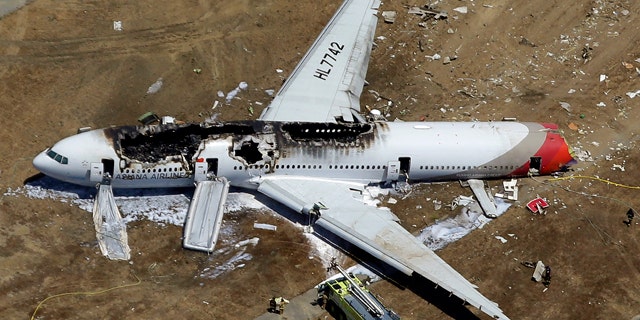 File - In this July 6, 2013, aerial file photo, the wreckage of Asiana Flight 214 lies on the ground after it crashed at the San Francisco International Airport in San Francisco. (AP Photo/Marcio Jose Sanchez, File)