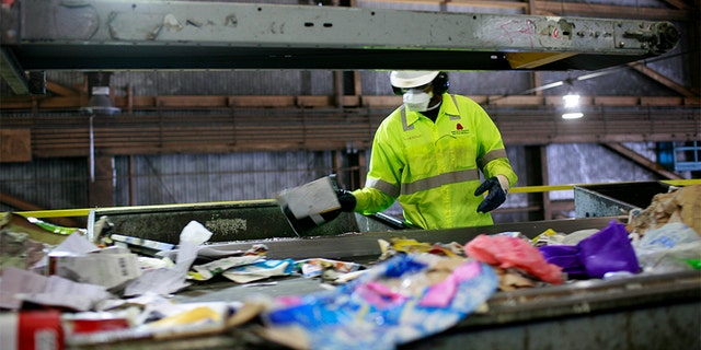 A worker sorts refuse at a San Francisco plant.