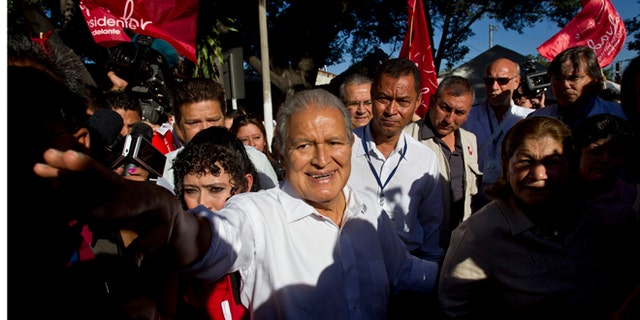 FILE - In this Feb. 2, 2014 file photo, Vice President Salvador Sánchez Cerén, presidential candidate for the ruling Farabundo Marti National Liberation Front (FMLN), greets supporters after voting at a polling station in San Salvador, El Salvador. Sanchez, a former guerrilla commander, is the favorite to win the second round presidential election Sunday, March 9, 2014. (AP Photo/Esteban Felix, File)