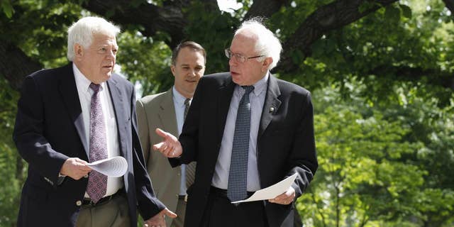 Sen. Bernie Sanders, I-Vt., right, talks with Rep. Jim McDermott, D-Wash., left, as they walk to news conference on Capitol Hill in Washington, Tuesday, May 10, 2011, to discuss their single-payer health care bills in the Senate and House. (AP Photo/Alex Brandon)