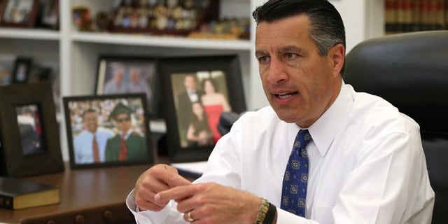 Nevada Gov. Brian Sandoval talks about the ongoing legislative session from his office at the Capitol in Carson City, Nev., on Friday, April 17, 2015. Sandoval says he's optimistic that lawmakers will reach a deal on the state's budget. (AP Photo/Cathleen Allison)