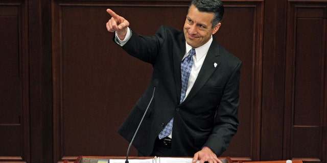 File - In a Thursday, Jan. 15, 2015 file photo, Nevada Gov. Brian Sandoval acknowledges a guest in the gallery during his State of the State address inside the Legislature building on the capital grounds in Carson City, Nev. Sandoval, who swept in to office with 71 percent of the vote, faces anger from other elected constitutional officers and several conservative Assembly members upset with his $7.3 billion, two-year budget that includes $1.1 billion in new and extended taxes. (AP Photo/Lance Iversen, File)