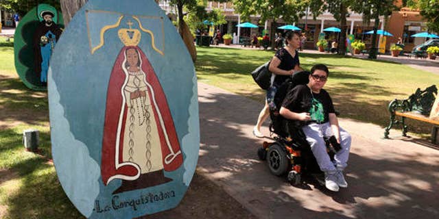 This Sept. 1, 2016 photo shows visitors of Santa Fe Plaza pass by an image of La Conquistadora, oldest statue of the Blessed Virgin Mary in the United States, as organizers prepare for the annual Santa Fe Fiesta. For centuries, northern New Mexico Hispanic residents have held an elaborate festival in Santa Fe in honor of Spanish conquistador Don Diego De Vargasâ who reclaimed the city following an American Indian revolt. But after 301 years, an emboldened group of Native American activists say itâs time to change a celebration centered around the conquest of New Mexicoâs Pueblo tribes. (AP Photo/Russell Contreras)