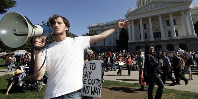 FILE: A Santa Monica College student calls to fellow protesters as they gather in Sacramento to demand higher funding for education.