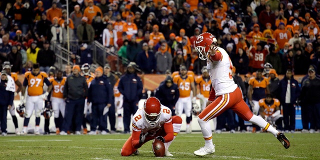 Kansas City Chiefs kicker Cairo Santos (5) kicks the game winning field goal as punter Dustin Colquitt (2) holds during overtime of an NFL football game against the Denver Broncos, Sunday, Nov. 27, 2016, in Denver. The Chiefs won 30-27 in overtime. (AP Photo/Joe Mahoney)