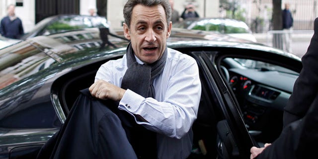 April 23: French President and UMP party candidate for the elections Nicolas Sarkozy arrives at his campaign headquarters the morning after the first round of voting in Paris.
