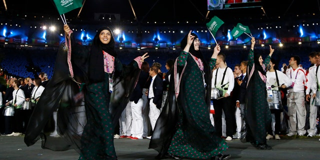July 27, 2012: Saudi Arabia's athletes parade, Wojdan Ali Seraj Abdulrahim Shaherkani , center, during the Opening Ceremony at the 2012 Summer Olympics, in London.
