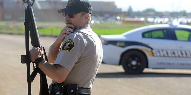 Lincoln County Sgt. Sheriff Terry Anderson guards the entrance of Harrisburg High School.