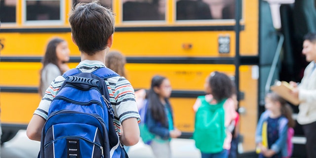 A student heads off to school on the bus.