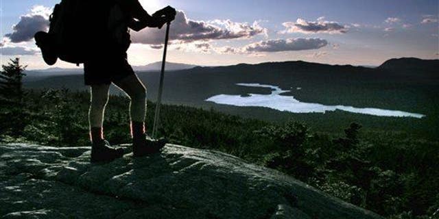 A hiker pauses on the Appalachian Trail in Maine.