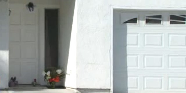 Mar. 24, 2012: Flowers lay in front of a home where a San Diego-area mother was beaten Wednesday morning.