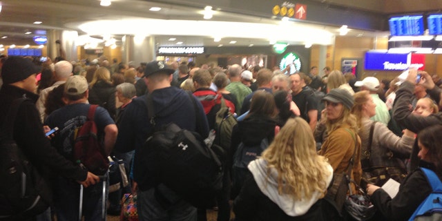 Mar. 19, 2013: Passengers wait at Seattle-Tacoma International Airport after a security breach.