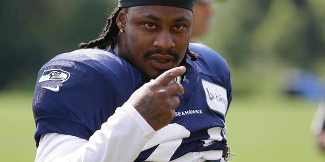 FILE -In this Aug. 2, 2014, file photo, Seattle Seahawks running back Marshawn Lynch walks on the field during NFL football training camp in Renton, Wash. Police in Bellevue, Washington, are investigating whether Lynch was involved in an assault and damage of personal property. The Bellevue Police Department released a statement Monday morning, Aug. 11, 2014, saying that the alleged incident took place around 2:30 a.m. Sunday and that Lynch is alleged to have been involved. (AP Photo/Ted S. Warren, File)