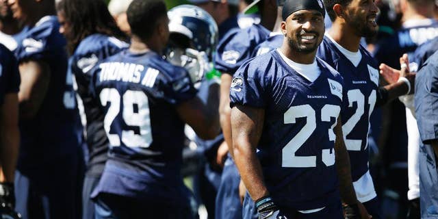 Seattle Seahawks strong safety Jeron Johnson (23) stands with teammates as the huddle breaks up following a session of NFL football training camp, Tuesday, Aug. 5, 2014, in Renton, Wash. (AP Photo/Ted S. Warren)