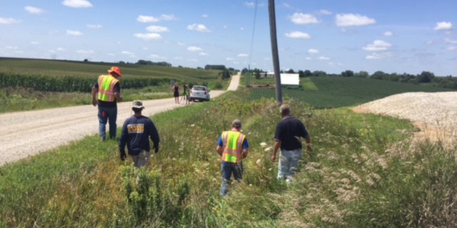 Search crews check ditches near the pig farm that was searched by FBI investigators last week.