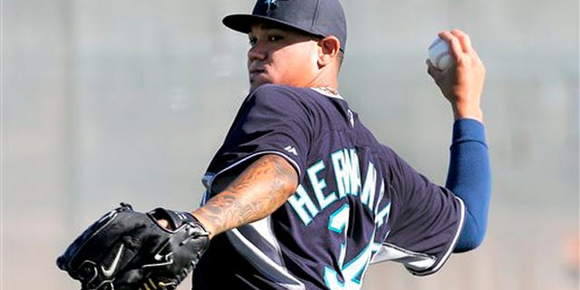Seattle Mariners pitcher Felix Hernandez throws during their first spring training baseball practice, Thursday, Feb. 13, 2014, in Peoria, Ariz. (AP Photo/Matt York)