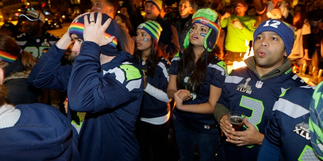 Feb. 1, 2015: Stunned Seattle Seahawks fans watching Super Bowl XLIX on outdoor TV screens react during the final minutes of the fourth quarter as the New England Patriots beat the Seahawks, 28-24. AP Photo/Ted S. Warren)