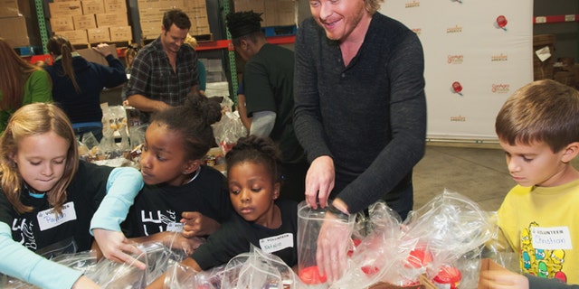 Nov.13, 2012: Phillip Sweet, center, and Nashville area children stuff backpacks in support of the Second Harvest Food Bank of Middle Tennessee Backpack program.