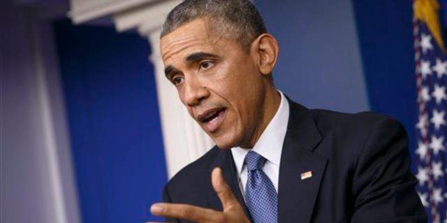 President Barack Obama speaks during a news conference in the Brady Press Briefing Room of the White House in Washington, Friday, Dec. 19, 2014. When the leaders of the U.S. and Cuba had their first phone conversation in more than 50 years, they were not at a loss for words. As President Barack Obama told the story at his news conference Friday, he opened his call with Cuban President Raul Castro _ brother of famously longwinded Fidel _ with a 15-minute monologue, then apologized for taking so much time. "He said, 'Don't worry about it, Mr. President, Obama related. You're still a young man, and you have still the chance to break Fidel's record. He once spoke seven hours straight." (AP Photo/J. Scott Applewhite)