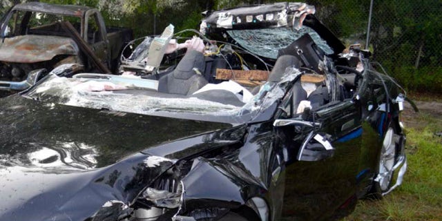 This photo provided by the NTSB via the Florida Highway Patrol shows the Tesla Model S that was being driven by Joshau Brown,who was killed, when the Tesla sedan crashed while in self-driving mode on May 7, 2016. (NTSB via Florida Highway Patrol via AP)