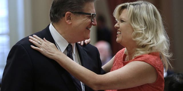 Hertzberg and state Sen. Cathleen Galgiani, D-Stockton, greet each other after their summer recess, at the Capitol in Sacramento, Calif., Aug. 17, 2015.