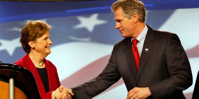 In this Thursday, Oct., 2014 photo, Democrat, U.S. Sen Jeanne Shaheen, left, shakes hands with her Republican opponent former Massachusetts U.S. Sen. Scott Brown before a live televised debate for U.S. Senate.