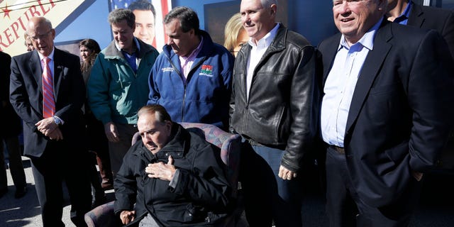Oct. 31, 2014: Former Sen. Bob Dole, R-Kan., seated, is backed by Sen. Pat Roberts, R-Kan., from left, Gov. Sam Brownback, New Jersey Gov. Chris Christie, Indiana Gov. Mike Pence and former Mississippi Gov. Haley Barbour during a campaign stop in Kansas City, Kan.