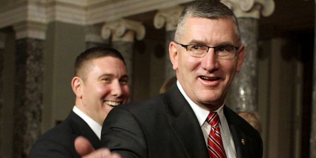In this Feb. 11, 2014, file photo, Sen. John Walsh, D-Mont., right, and his son Michael leave the Old Senate Chamber on Capitol Hill in Washington, D.C, after a ceremonial swearing-in ceremony with Vice President Joe Biden.
