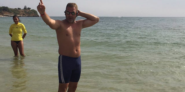 Ben Hooper, 38, a former policeman from, United Kingdom gesture before his Swimming expedition across the Atlantic in Dakar, Senegal, Sunday, Nov. 13, 2016. Ben Hooper has been planning to make the epic endeavour for more than three years to become the first person to swim the full 1,635 nautical miles from Senegal to Brazil. (AP Photo/Carley Petesch)