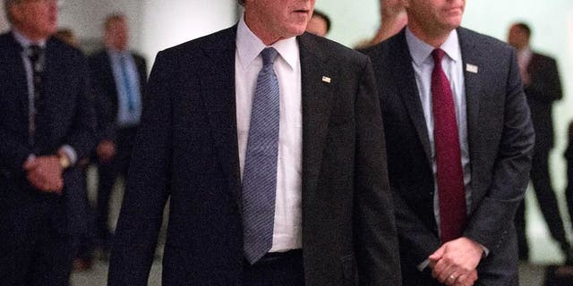 In this photo taken on Sunday, Dec. 14, 2014, and provided by the National September 11 Memorial and Museum, former President George W. Bush, center, makes an unannounced visit to the National September 11 Memorial &amp; Museum in New York. At right is National September 11 Memorial &amp; Museum President Joe Daniels.