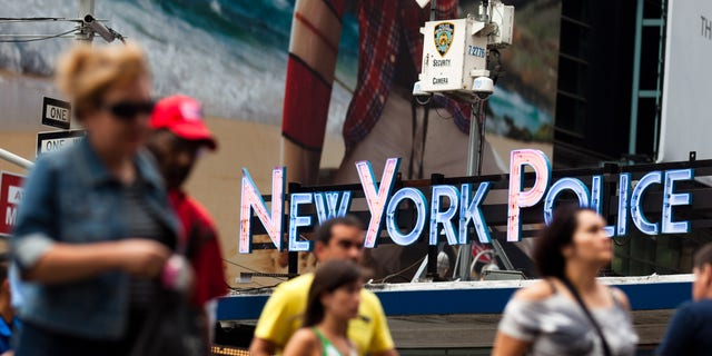 Pedestrians start their morning under the watchful eyes of surveillance cameras in Times Square in New York, Tuesday, Aug. 19, 2011. Since the terrorist attacks of Sept. 11, 2001, the NYPD has become one of the country's most aggressive domestic intelligence agencies, targets ethnic communities in ways that would run afoul of civil liberties rules if practiced by the federal government. (AP Photo/John Minchillo)