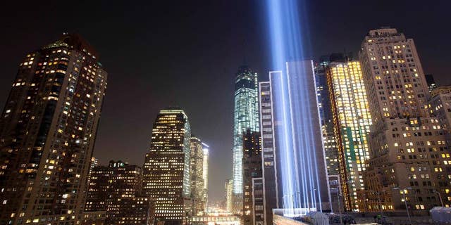 FILE- In this Sept. 10, 2013 file photo, the Tribute in Light rises into the night sky during a test in New York. The National September 11 Memorial and Museum will be closed to the public during the September 11 commemoration ceremony and much of the rest of the day, but it will be open from 6 p.m. to midnight for anyone who wants a close up view of the Tribute in Light. (AP Photo/Mark Lennihan, File)