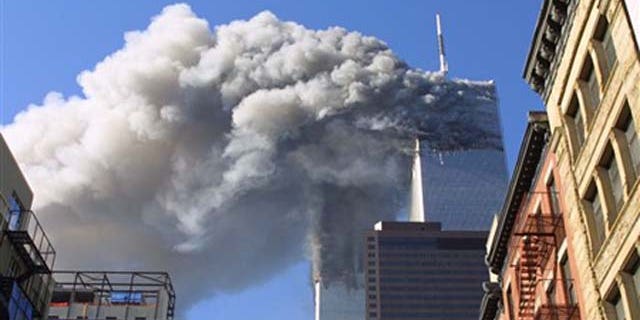 FILE - In this Sept. 11, 2001 file photo, the twin towers of the World Trade Center burn after hijacked planes crashed into them in New York. As the post-Sept. 11 decade ends, some foreign families of the victims are eager to move past the tragedy. But though the pain transcended borders, foreign families have battled to cope with their loss from afar.