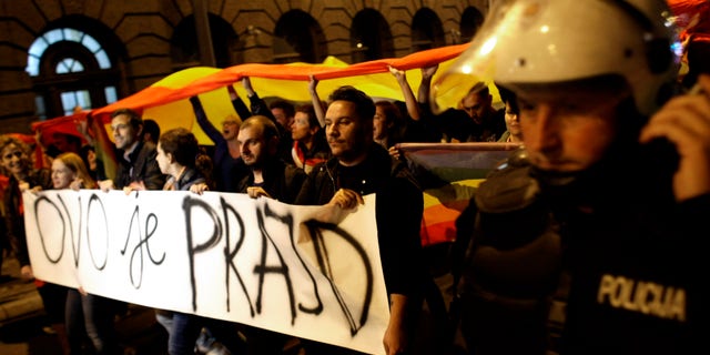Sept. 27, 2013: Gay rights activists hold up a large rainbow flag and a banner reading "This is the Pride"; during a protest in Belgrade, Serbia.