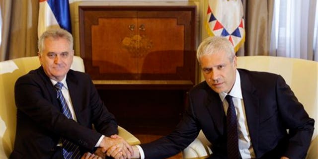 May 28, 2012: Newly elected Serbian President Tomislav Nikolic, left, shakes hands with former president Boris Tadic during meeting in the Serbian presidency building, in Belgrade, Serbia.