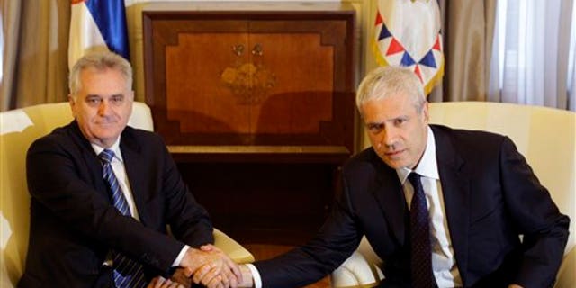 May 28, 2012: Newly elected Serbian President Tomislav Nikolic, left, shakes hands with former president Boris Tadic during meeting in the Serbian presidency building, in Belgrade, Serbia.