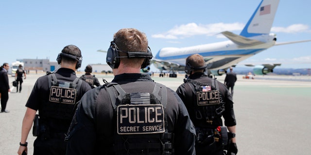 FILE: July 23, 2014: U.S. Secret Service employees walk toward Air Force One at San Francisco International Airport, San Francisco, Calif.