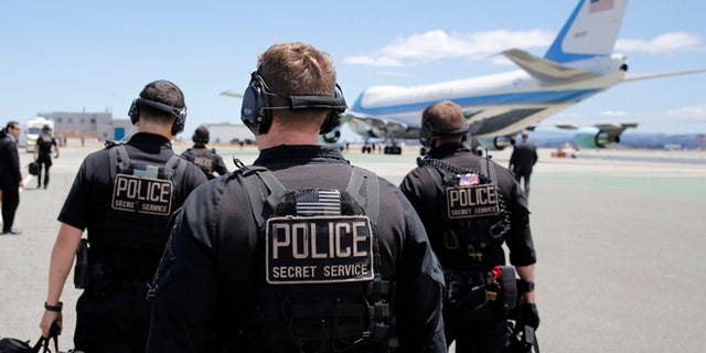 FILE: July 23, 2014: U.S. Secret Service employees walk toward Air Force One at San Francisco International Airport, San Francisco, Calif.
