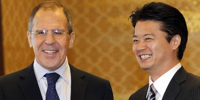 January 28, 2012: Russian Foreign Minister Sergey Lavrov, left, shakes hands with his counterpart Koichiro Gemba prior to their meeting in Tokyo.