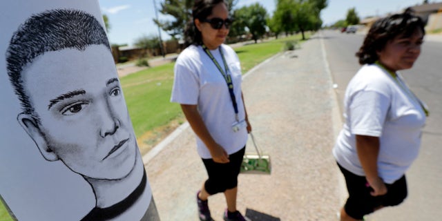Phoenix neighborhood patrol officers walk Maryvale neighborhood streets in Phoenix, Ariz.