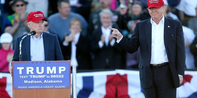 Republican presidential candidate Donald Trump, right, gestures as Sen. Jeff Sessions, R-Ala., speaks during a rally Sunday, Feb. 28, 2016, in Madison, Ala. (AP Photo/John Bazemore)