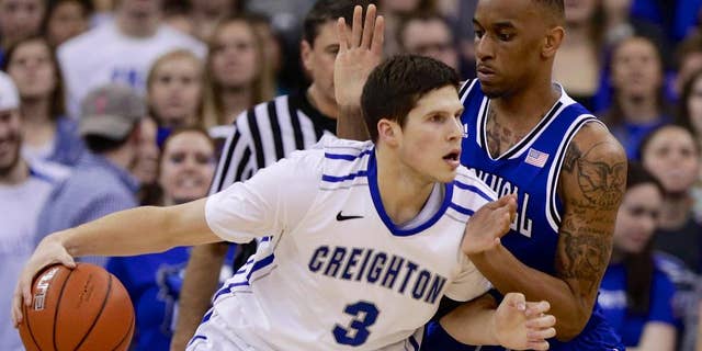 Creighton's Doug McDermott (3) drives around Seton Hall's Brandon Mobley (2) in the first half of an NCAA college basketball game in Omaha, Neb., Sunday, Feb. 23, 2014. (AP Photo/Nati Harnik)