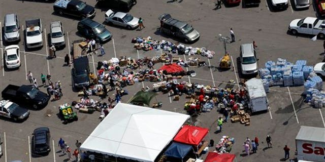 April 30: Tuscaloosa residents gather in a parking lot where food, water, and supplies are being distributed to those in need in Tuscaloosa, Ala.. (AP)