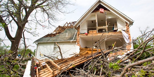 A house sits ripped-open from a tornado on Sunday, April 15, 2012 in Thurman, Iowa. Thurman appeared to be the hardest hit community in Iowa, but storms caused damage elsewhere in the state, as well as in Nebraska. There were more than 100 reports of tornadoes across the middle of the country through dawn Sunday, forecasters said. (AP Photo/The Journal-Star, Patrick Breen)